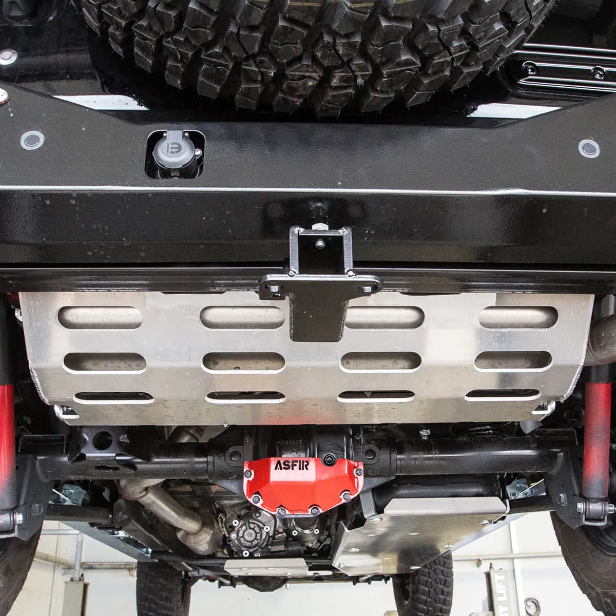 ASFIR skid plate and red differential guard under a Jeep