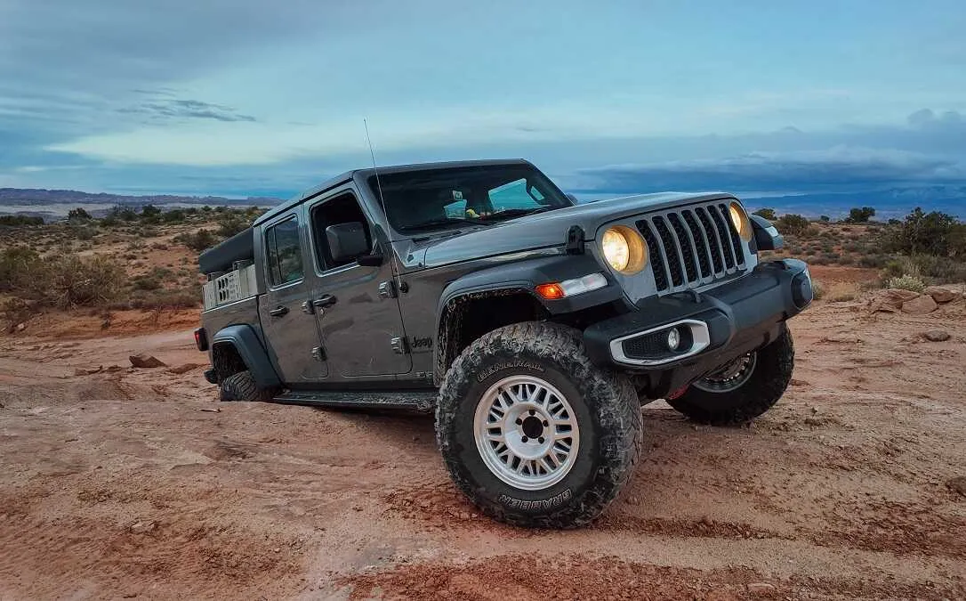Jeep Gladiator with ASFIR rock sliders on a red dirt trail